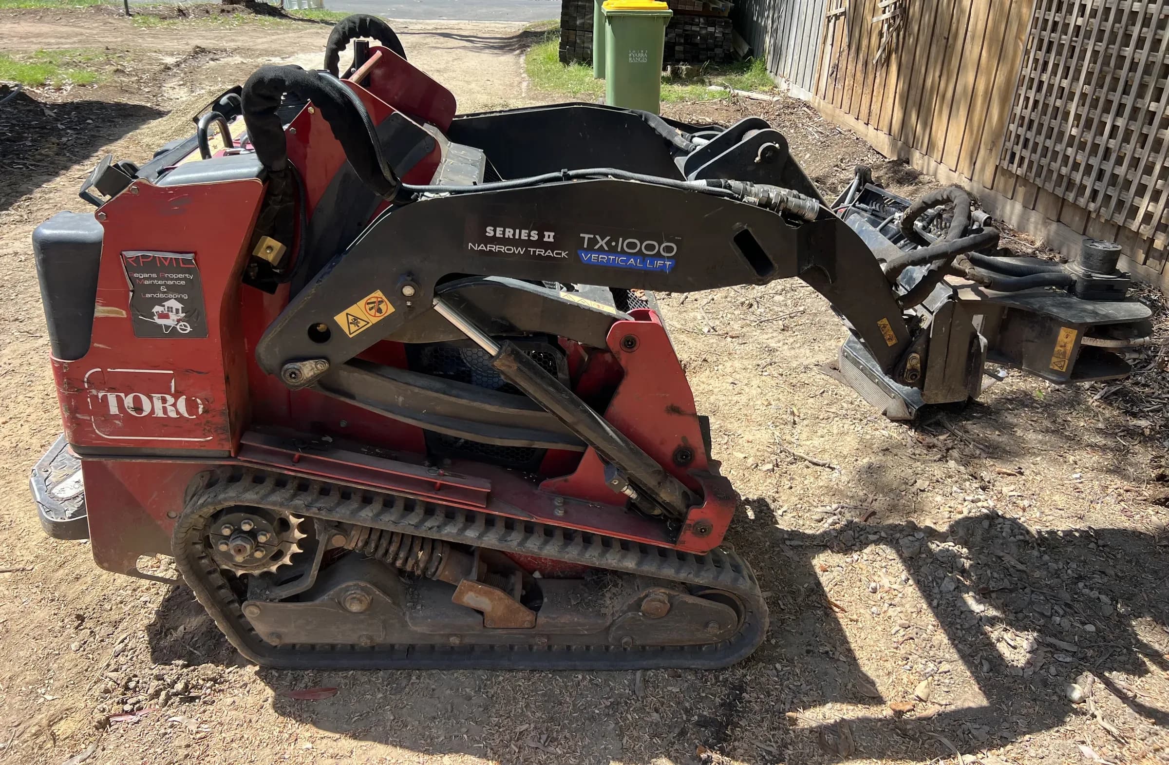 Toro TX-1000 narrow-track loader fitted with a stump grinder attachment on site