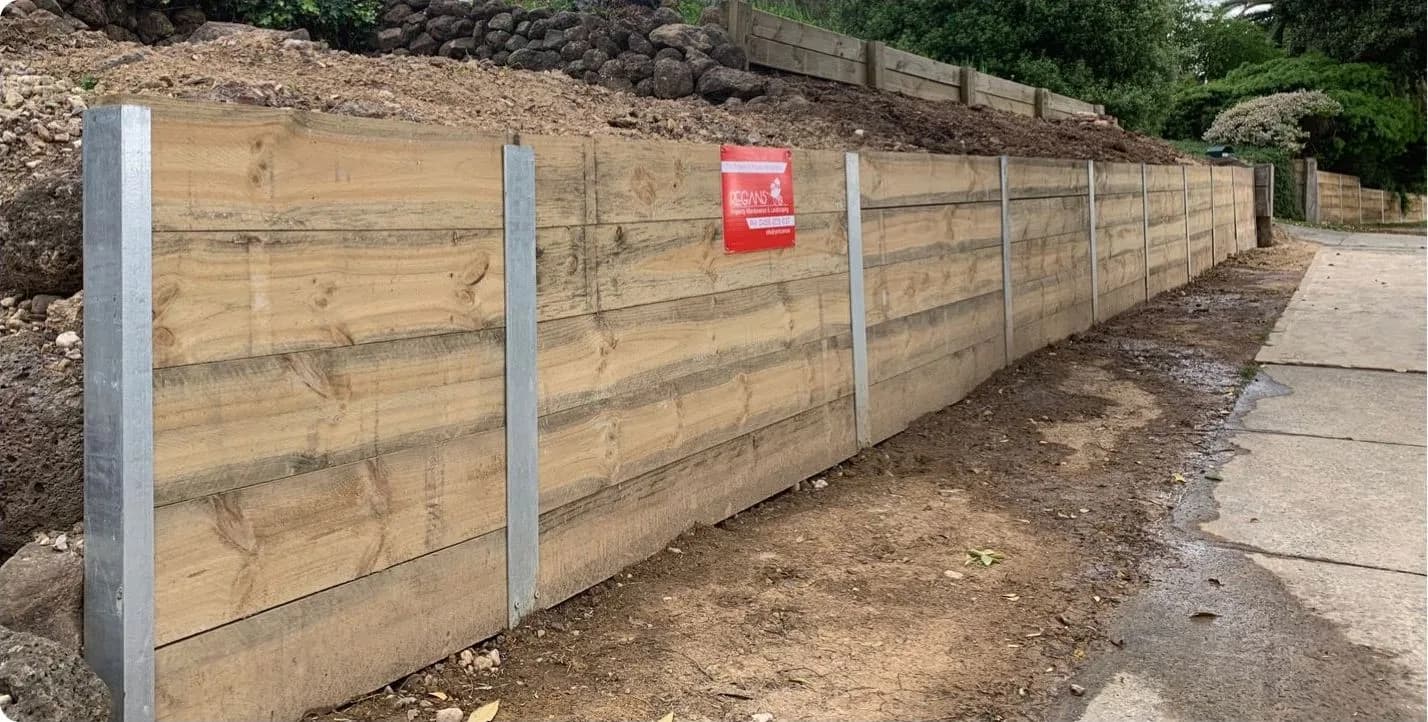 The same frontage rebuilt as a timber sleeper retaining wall on galvanised posts